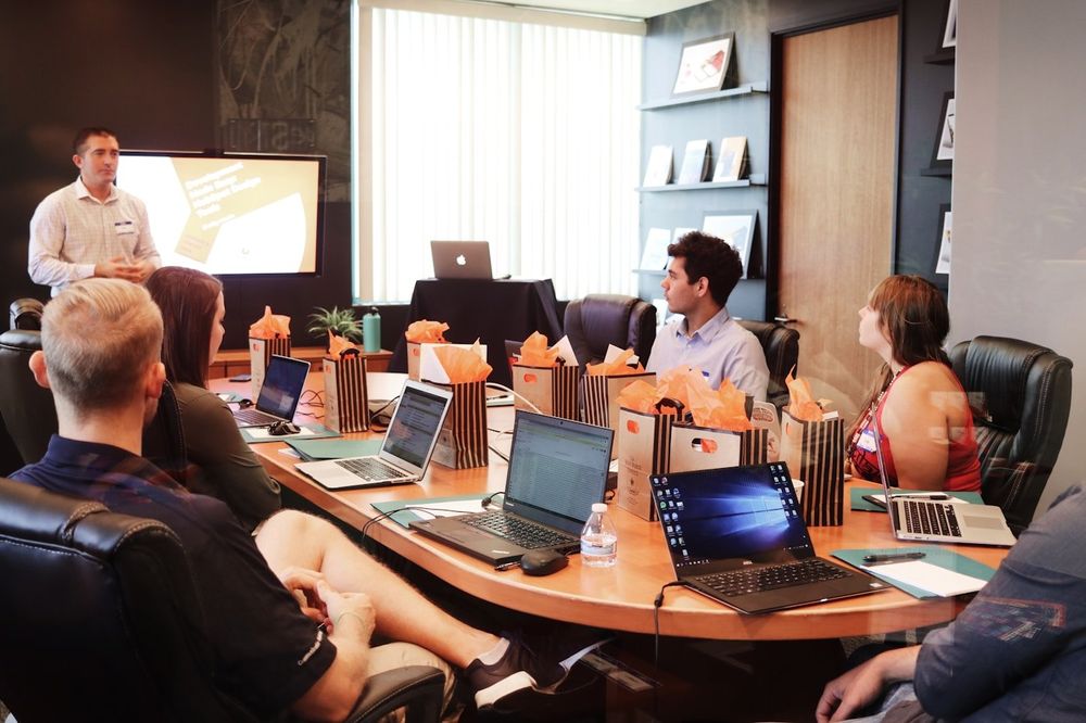 A professional delivering a presentation in a boardroom